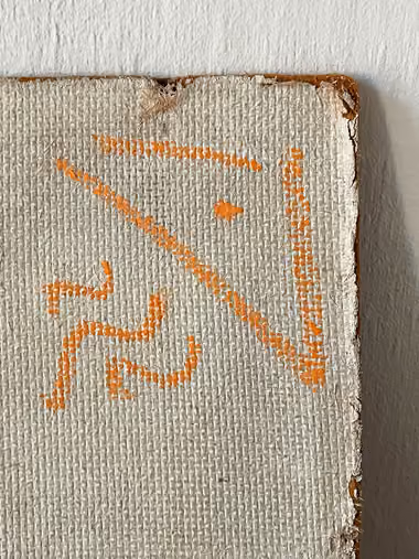 The edge of the panel and a corner of the work